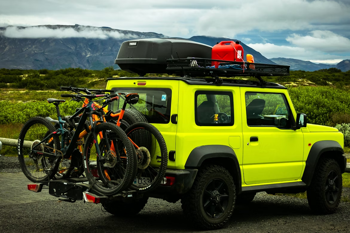 Image of a car carrying bicycles securely mounted on bicycle racks during a trip.